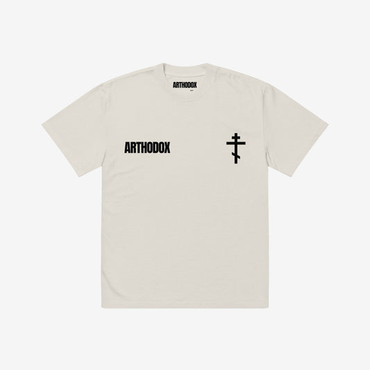 Faded bone T-shirt featuring the minimalist ARTHODOX wordmark on the left chest and an Orthodox Christian cross on the right. www.arthodox.com
