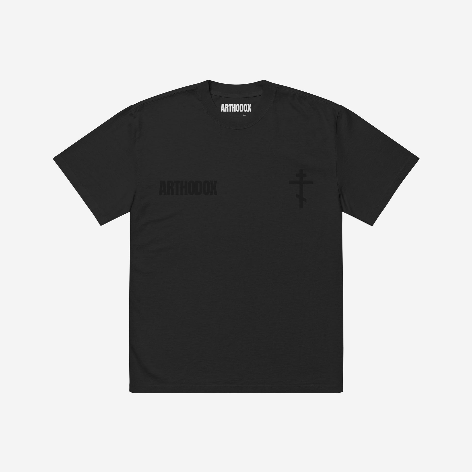 Faded black T-shirt featuring the minimalist ARTHODOX wordmark on the left chest and an Orthodox Christian cross on the right. www.arthodox.com