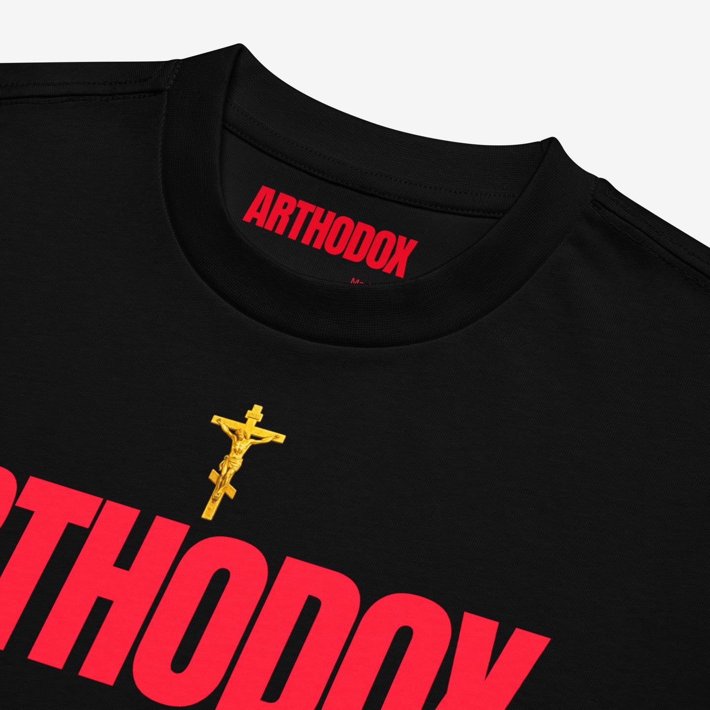 Black unisex oversized tee with a golden Orthodox Christian cross and bold red text ARTHODOX. Closeup print details. www.arthodox.com