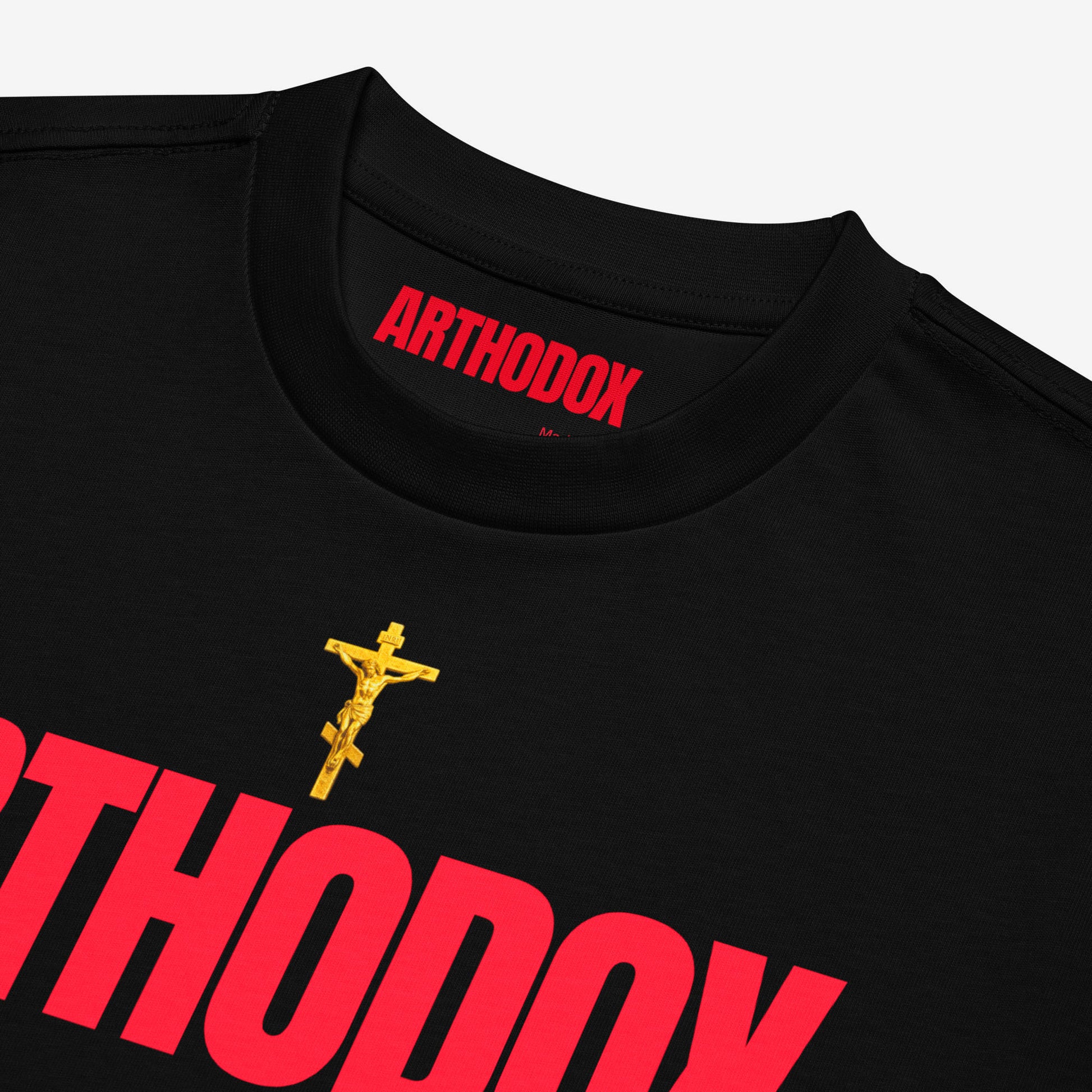 Black unisex oversized tee with a golden Orthodox Christian cross and bold red text ARTHODOX. Closeup print details. www.arthodox.com