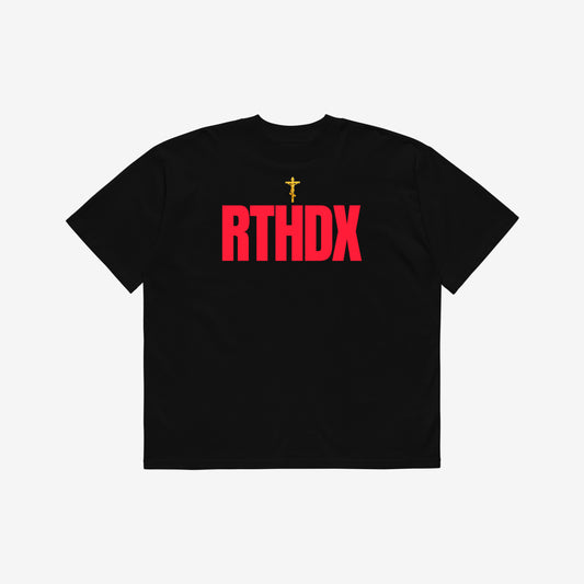 Black unisex oversized high-neck tee featuring a golden Orthodox Christian cross and bold red disemvowelled ARTHODOX, RTHDX. www.arthodox.com